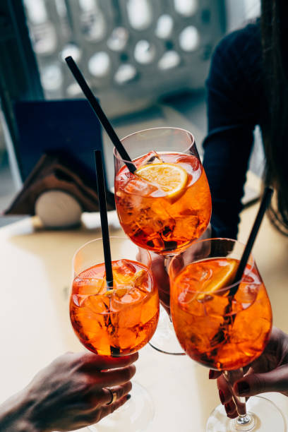 Making a celebratory toast with Spritz cocktails