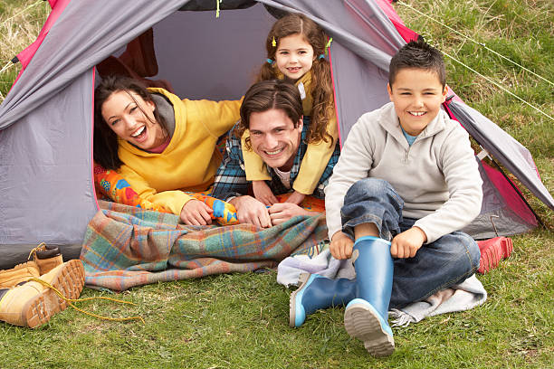 istock Young Family Relaxing Inside Tent On Camping Holiday 114276007