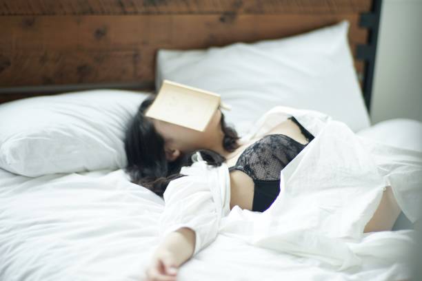 istock Young woman reading at home 1142760237
