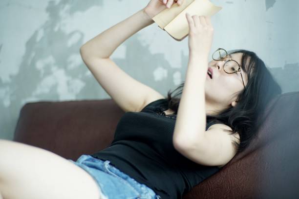 Young woman reading at home,Japan
