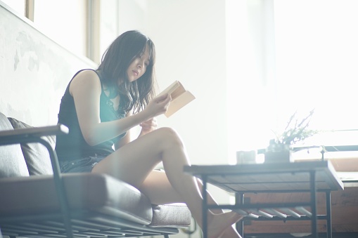 Young woman reading at home,Japan