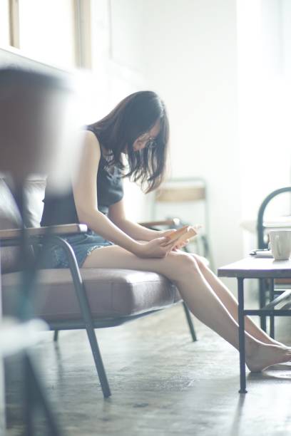 istock Young woman reading at home 1142761491