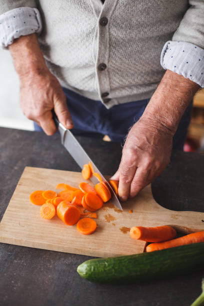 istock Cut out of man cutting fresh vegetables 1142761958