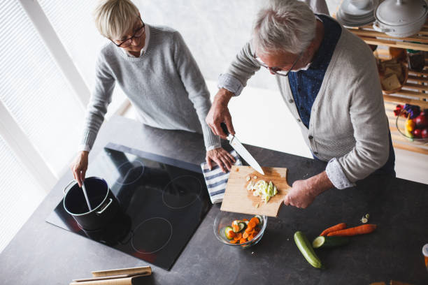 istock Senior couple preparing a meal together 1142761992