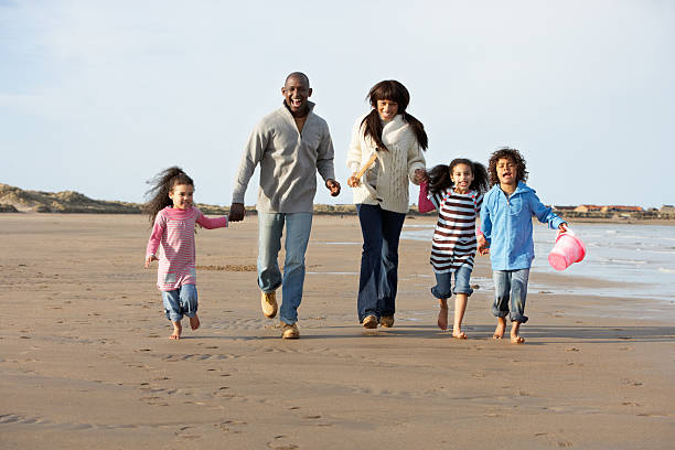 istock Family Running On Beach 114276210