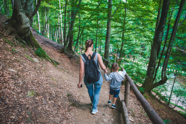 istock mother with son walking forest trail holding hands 1142762184