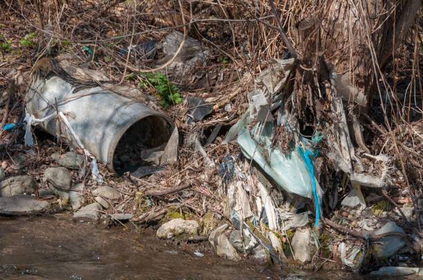 istock Plastic and foam garbage floating on the surface of the river 1142764875