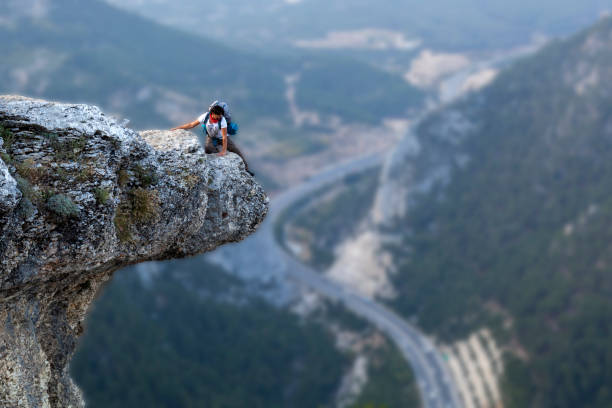 istock Mountaineer on dangerous rock 1142766155