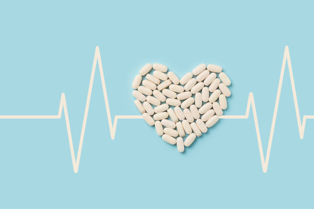 Heart shape from pills with cardiogram. Concept healthcare on blue background. Heart shape from pills with cardiogram. Concept healthcare on blue background. Top view, copy space aspirin photos stock pictures, royalty-free photos & images