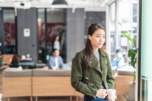 istock Asian businesswoman at tea break 1142769347