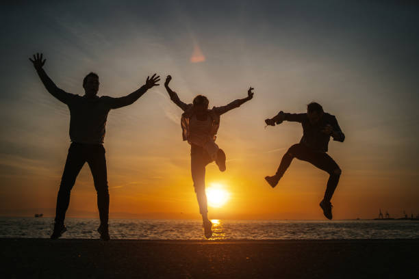 istock Cheerful friends enjoying sunset at sea 1142770847