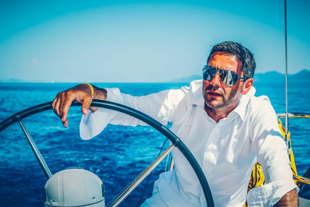 istock Man sailing with sailboat 1142772116