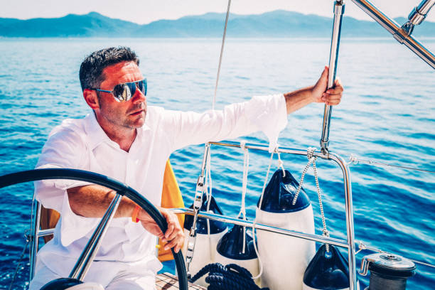 istock Man sailing with sailboat 1142772171