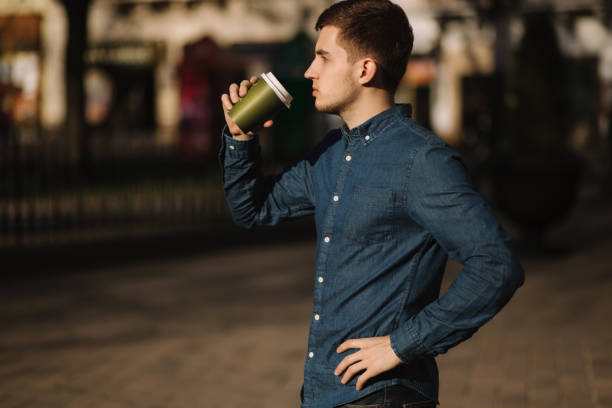 istock Young boy drink coffee outside. Spring sunset 1142774391