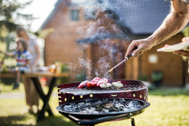 istock Unrecognizable man preparing barbecue in the backyard. 1142774605