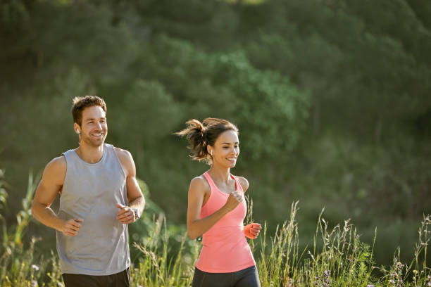 istock Smiling determined couple jogging at park 1142775513