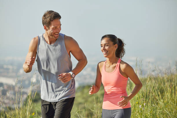 istock Happy couple talking while jogging at park 1142775694