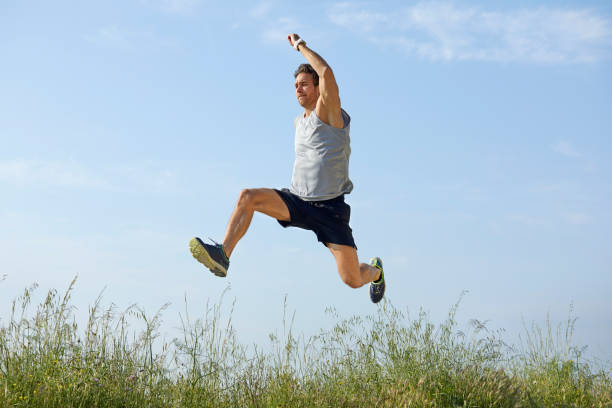 istock Sporty man jumping at park during summer 1142775749