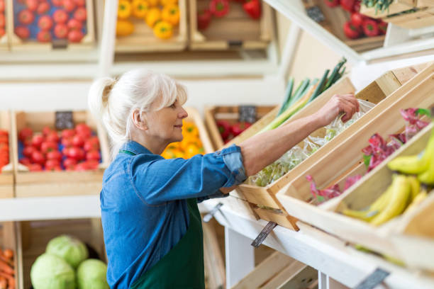istock Senior woman working in small grocery store 1142775995