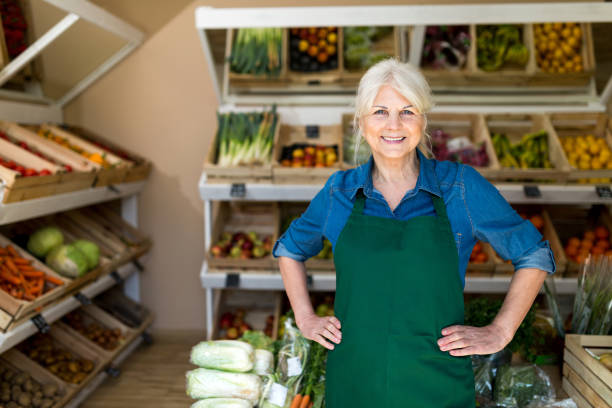 istock Senior woman working in small grocery store 1142776010