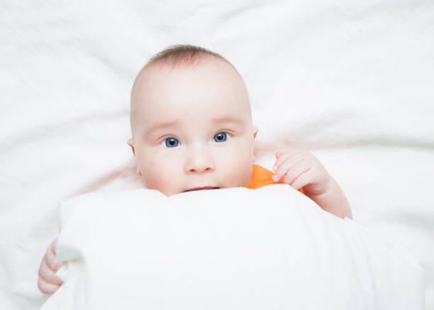 istock Baby looks out from under the blanket. 1142778715