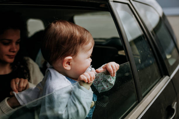 istock Toddler With Mother Looking Through Car Window 1142781725