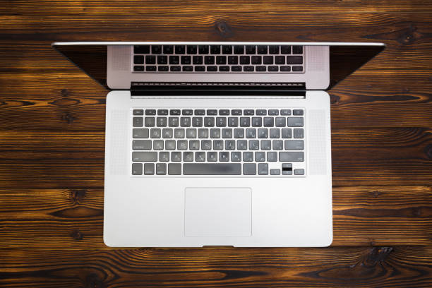 istock laptop on wooden background top view- Image 1142782356