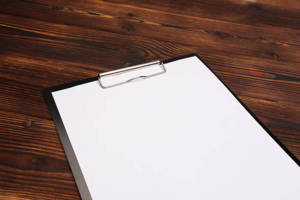 istock Clipboard with white sheet on wood background. Top view. - Image 1142782608