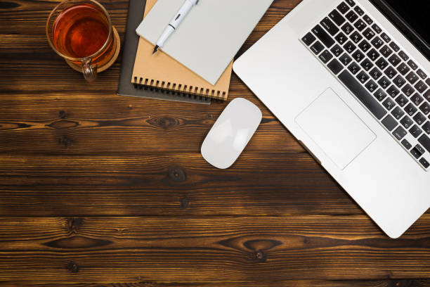 istock Top view wooden office  desk  with copy space - Image 1142782737