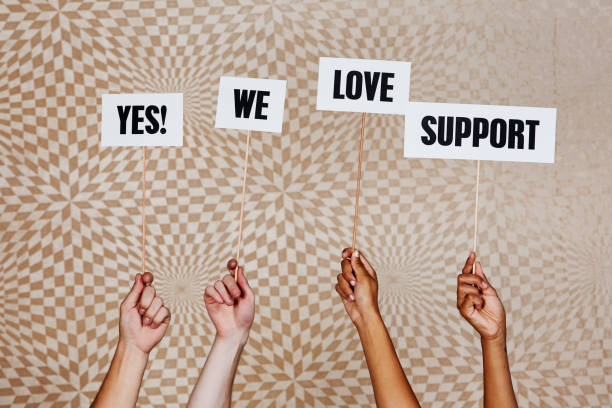 istock Raised hands hold signs reading 
