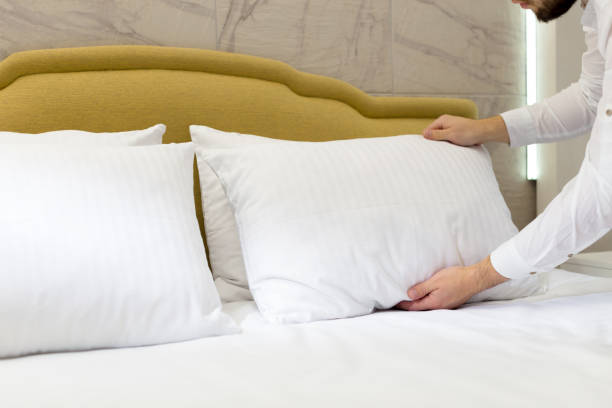 istock hotel staff setting up pillow on bed 1142786470