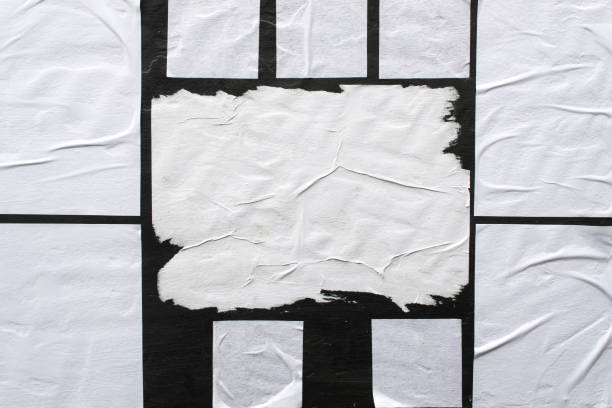 istock Several sheets of white paper pasted on a black wall. 1142787942
