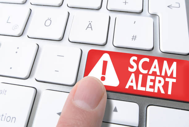 istock finger pressing red key labeled SCAM ALERT on computer keyboard 1142787969