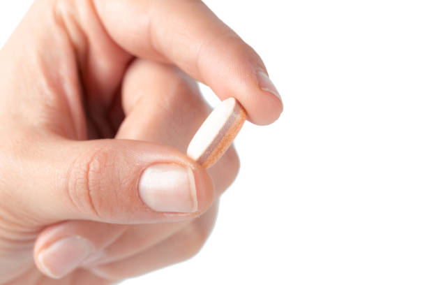 istock pills in woman hand 1142787987