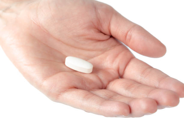 istock pills in woman hand 1142788045
