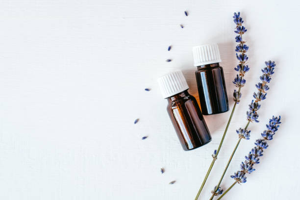 dried lavender with a bottle of essential oil - aromatic oil imagens e fotografias de stock