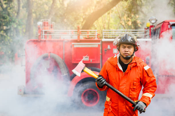 Firefighters fighting a fire operation, fireman holding ax, Fire truck on backgrounds