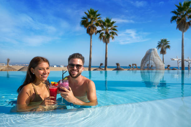 istock Tourist couple having bath in infinity pool 1142790586