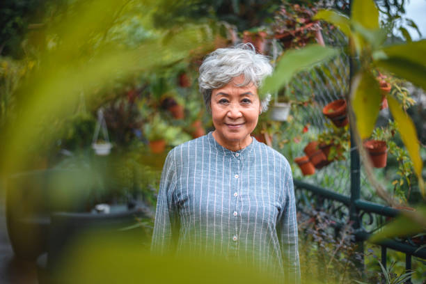 istock Smiling senior woman looking away in back yard 1142791455