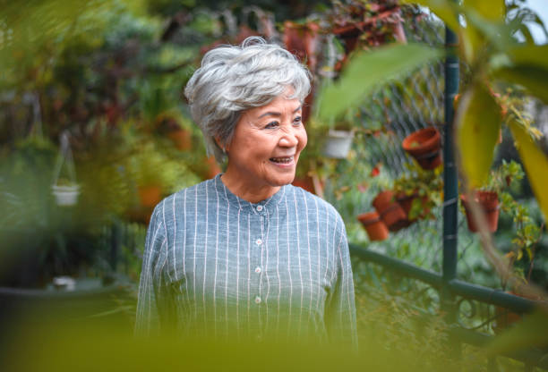 Smiling senior woman looking away in back yard