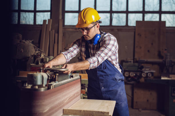 istock Carpenter working on woodworking machines in carpentry shop 1142791815