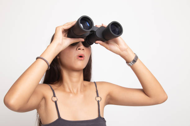 istock Young Asian woman with binoculars. 1142791821