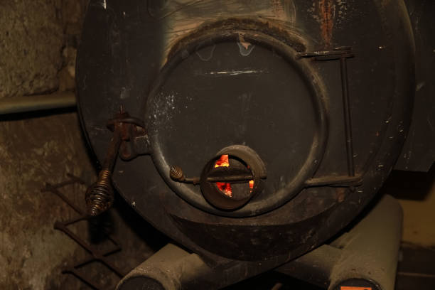 istock fire in a large iron, black stove 1142792260
