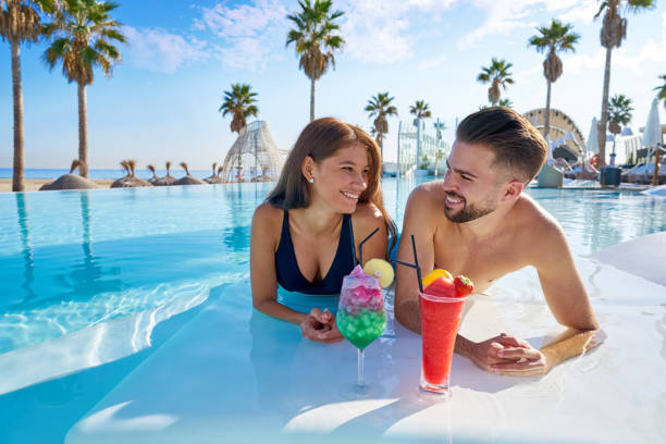 istock Young couple on infinity pool cocktails 1142792404