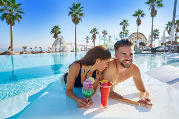 istock Young couple on infinity pool cocktails 1142792446