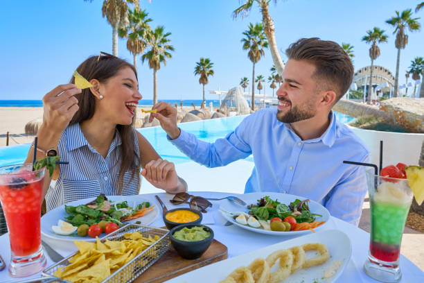 istock Young couple eating in a pool restaurant 1142794144