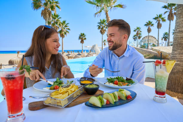 istock Young couple eating in a pool restaurant 1142794216