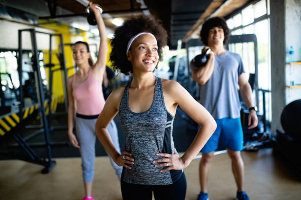 istock Group of young people doing exercises in gym 1142796319