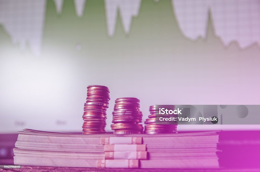 Money with coins and diagrams on background. Dollars photo. Inflation rates. Price growth. Exchange house and broker's board. Economics concept. Arrow Symbol Stock Photo