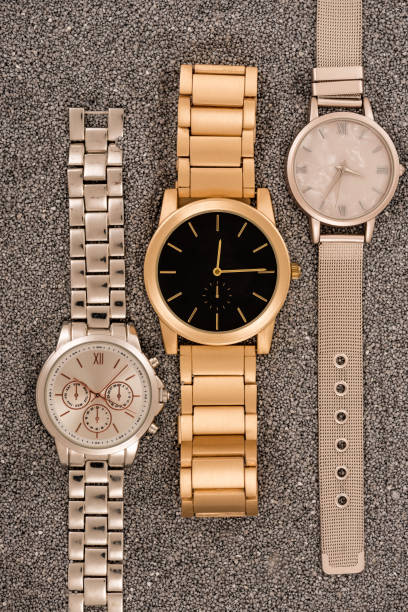 istock top view of luxury wristwatches lying on golden sand 1142800708